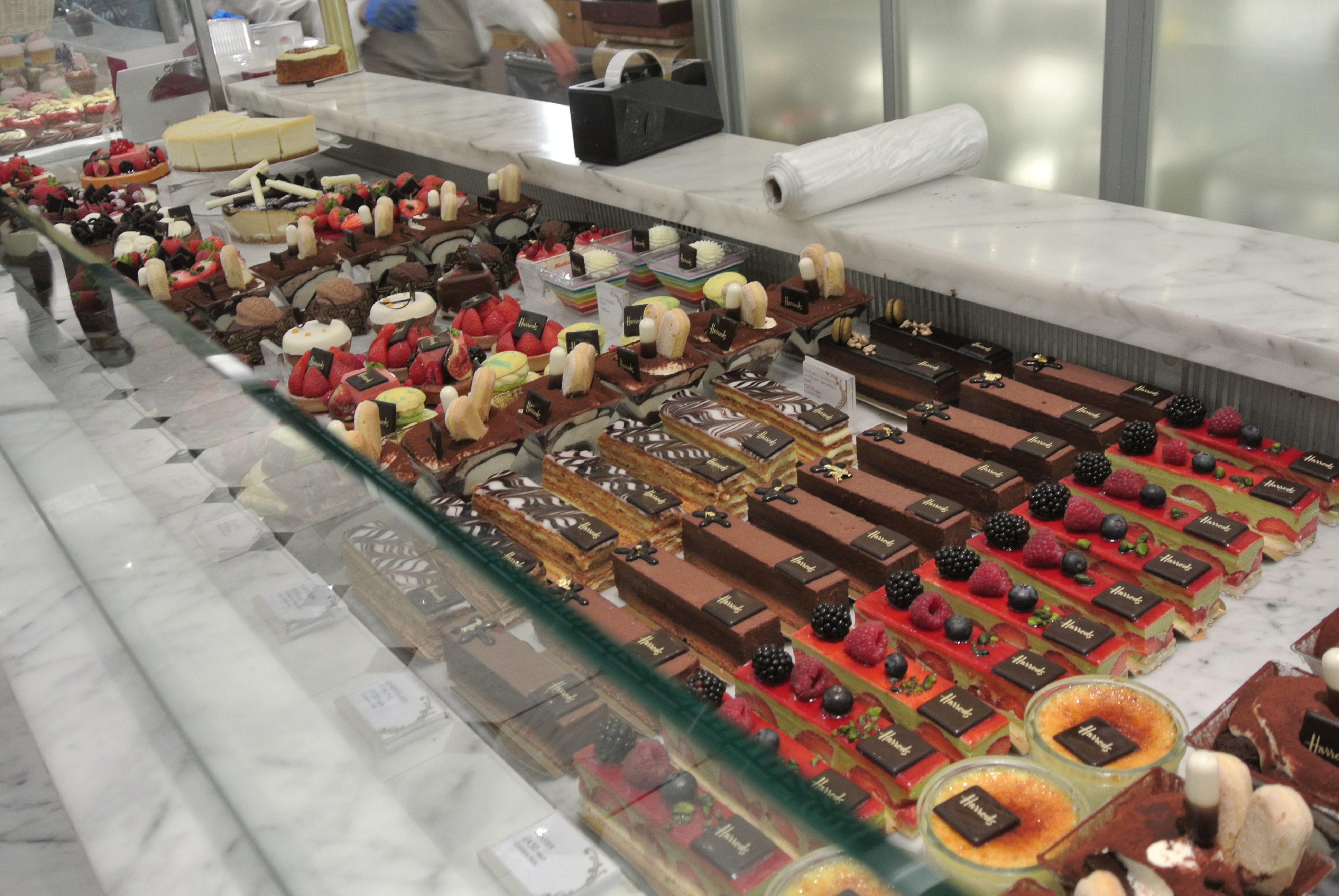 An entire row of beautiful pastries so perfectly laid out.