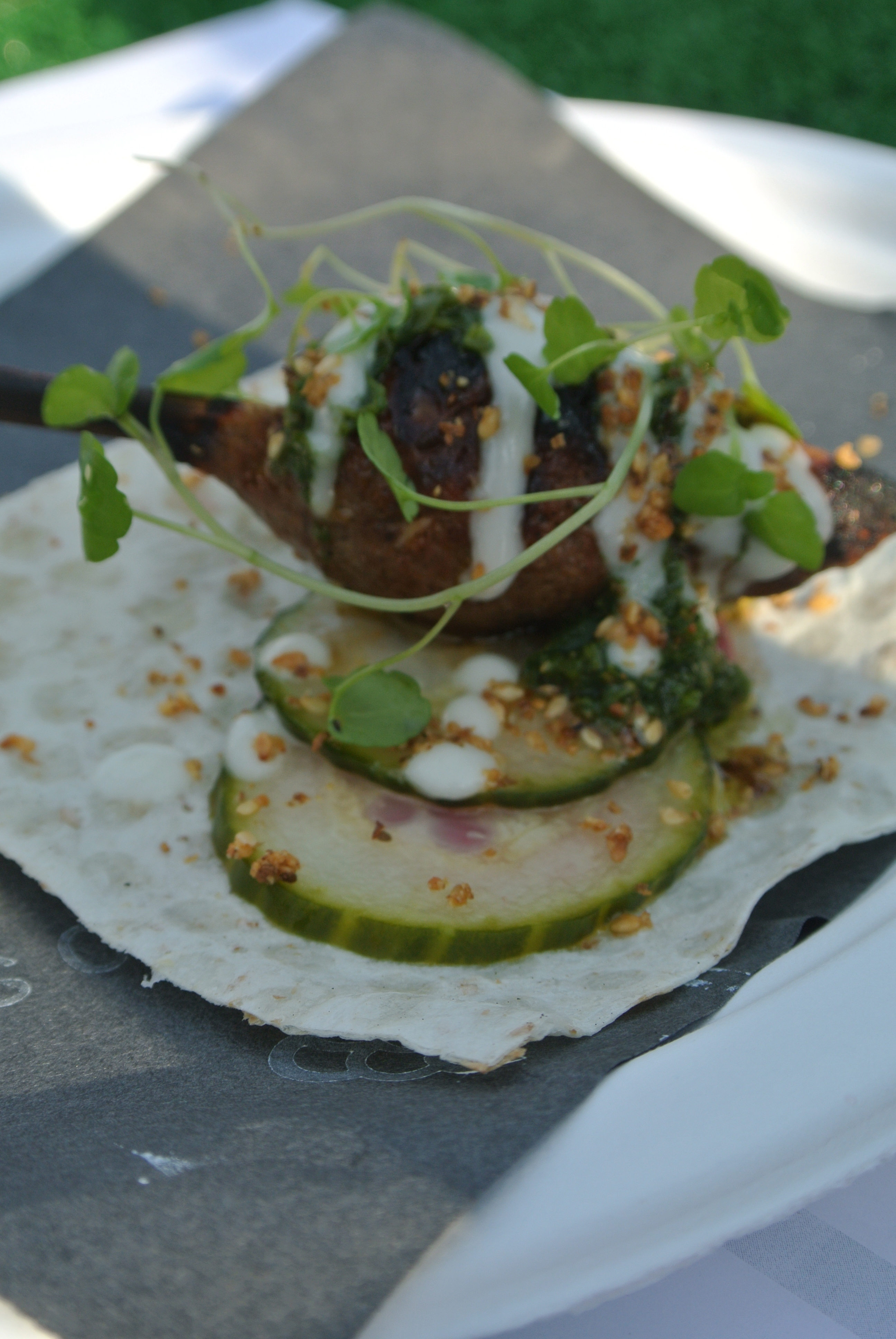 Byblos' charcoal grilled lamb kofte with house pickles, toum and green schug.
